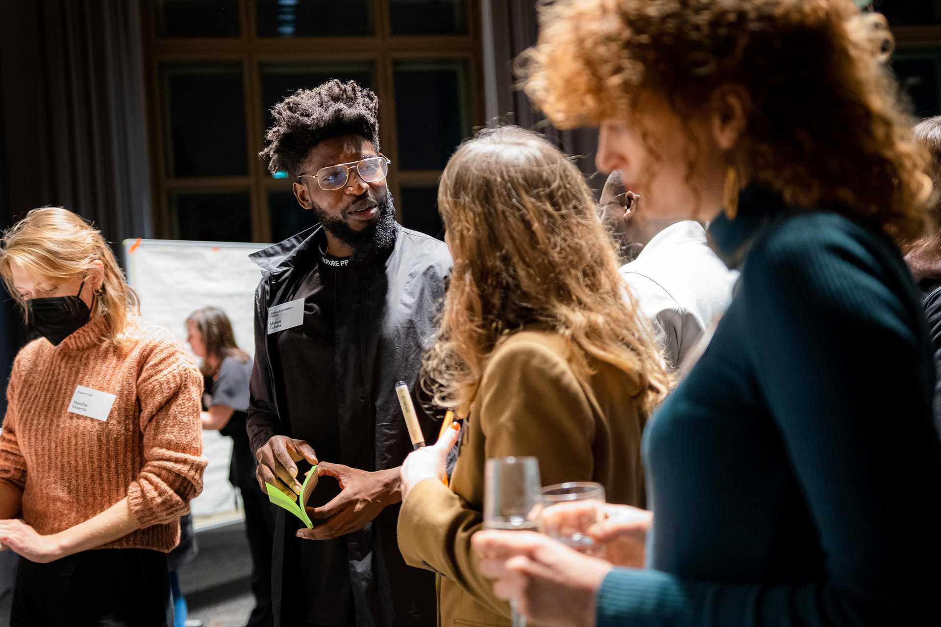 Allianz Foundation Fellow Makan Fofana speaks to another guest of the lauch event.